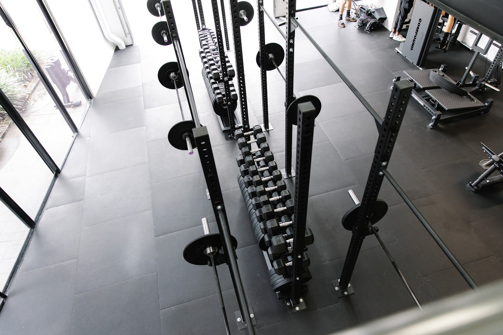 High-angle view over the rig and floor of a boutique gym by Compound Fitness