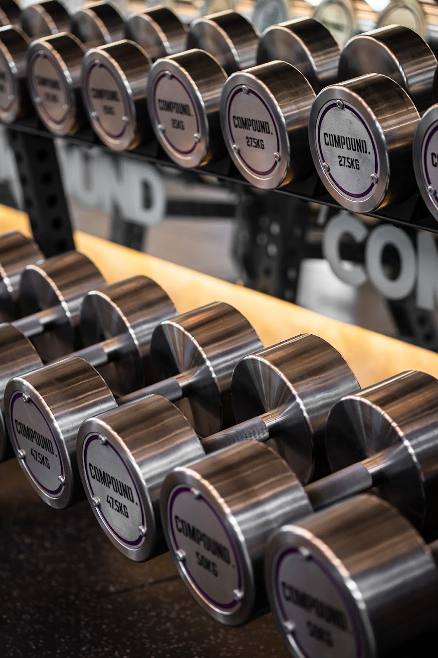 Compound branded stainless dumbbell set in a 24/7 gym fitout