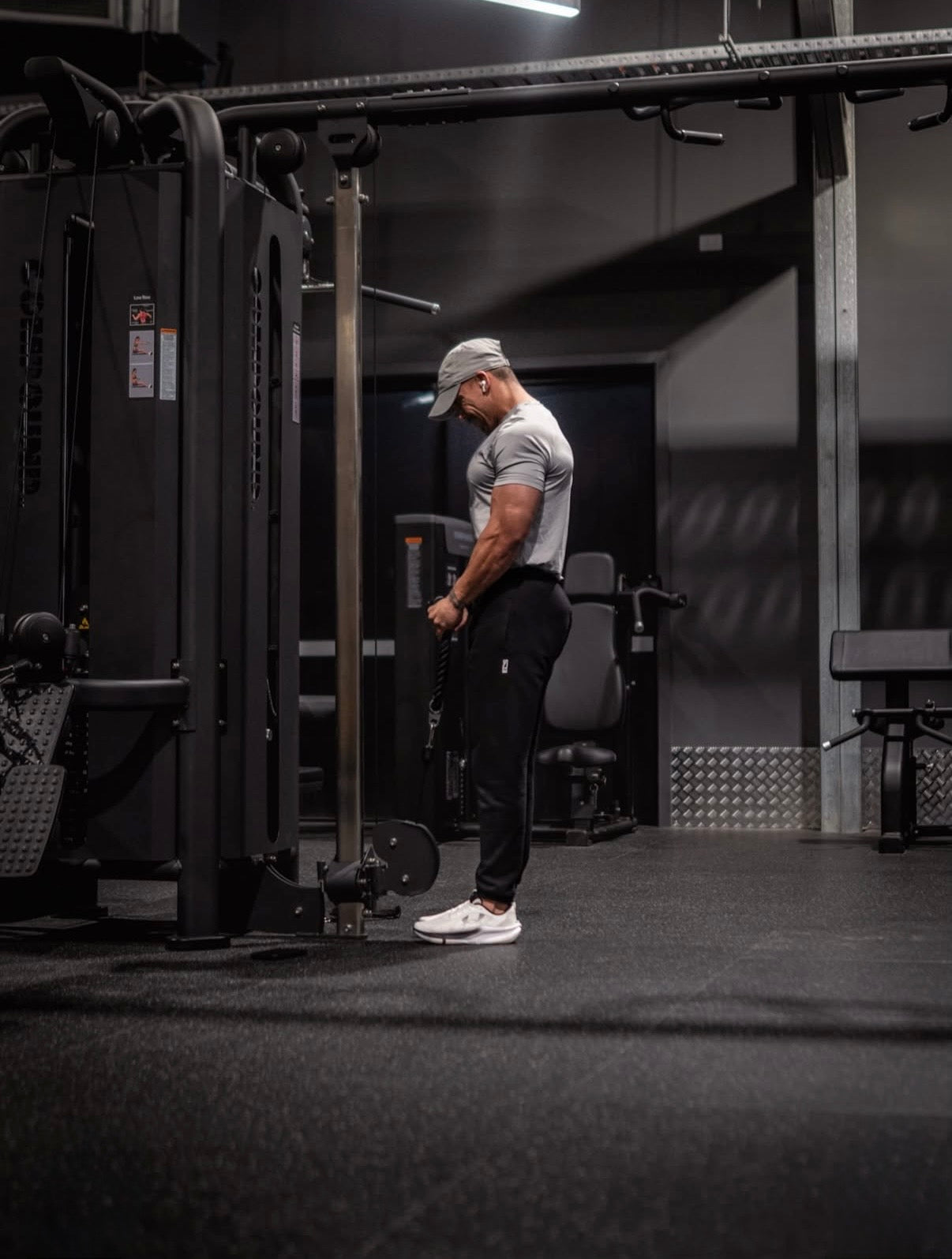 Member training on a cable machine in a 24/7 gym fitout by Compound Fitness