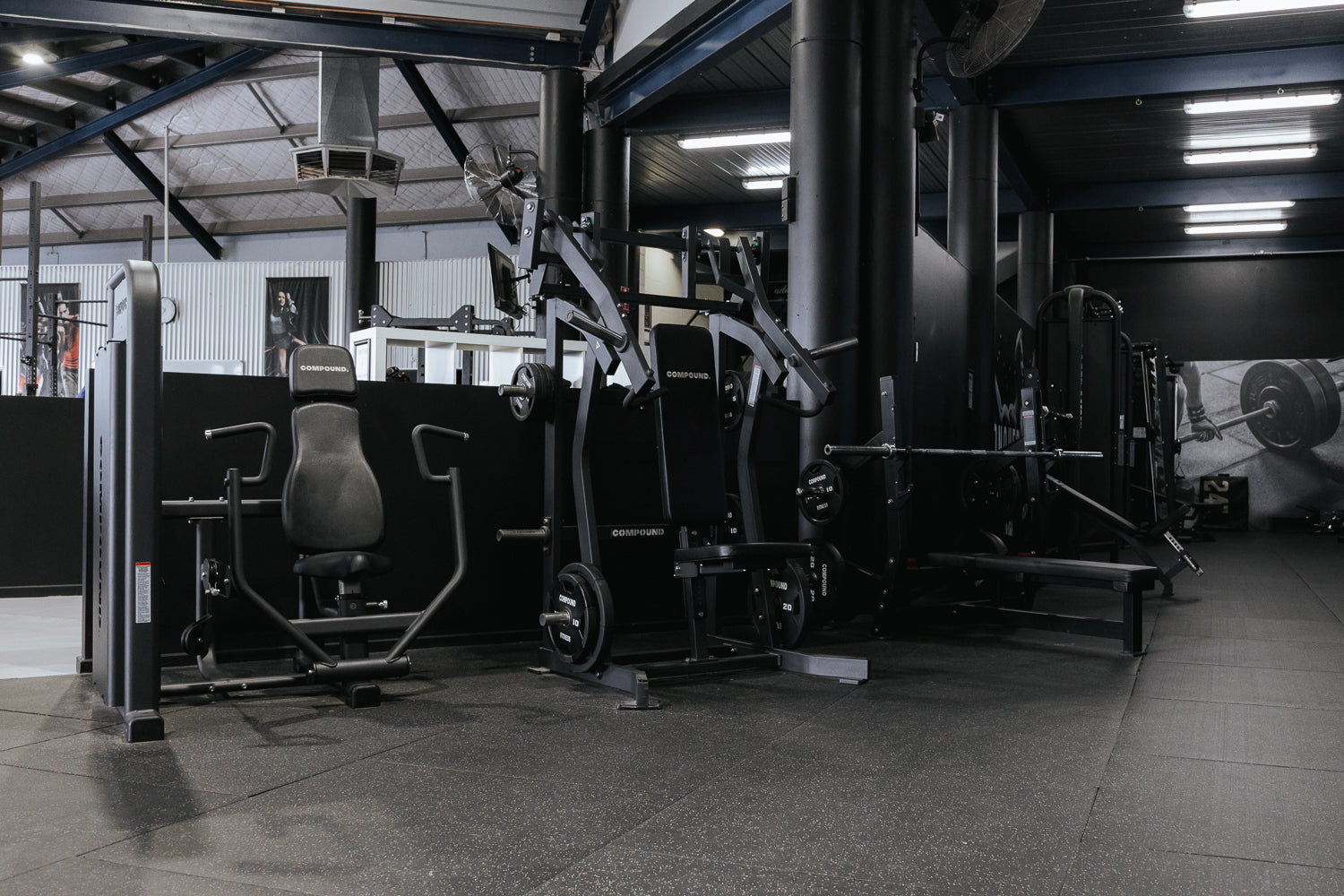Full 24/7 gym floor with pin-loaded machine row by Compound Fitness
