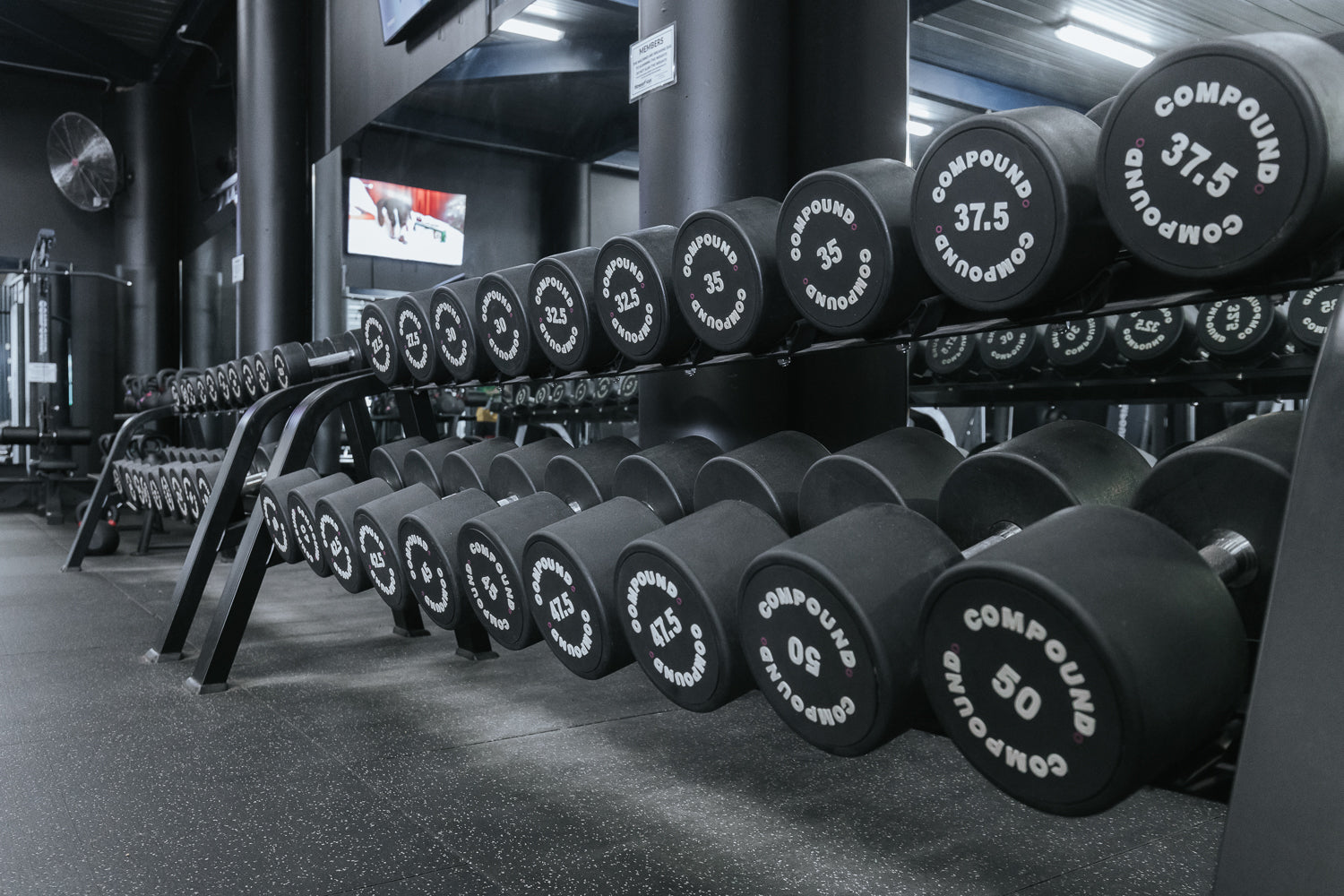 Dumbbell rack run and open training floor in a 24/7 gym fitout by Compound Fitness